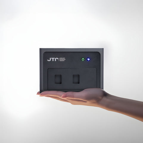 REVEAL diamond detector 2s  held in a hand against a white background